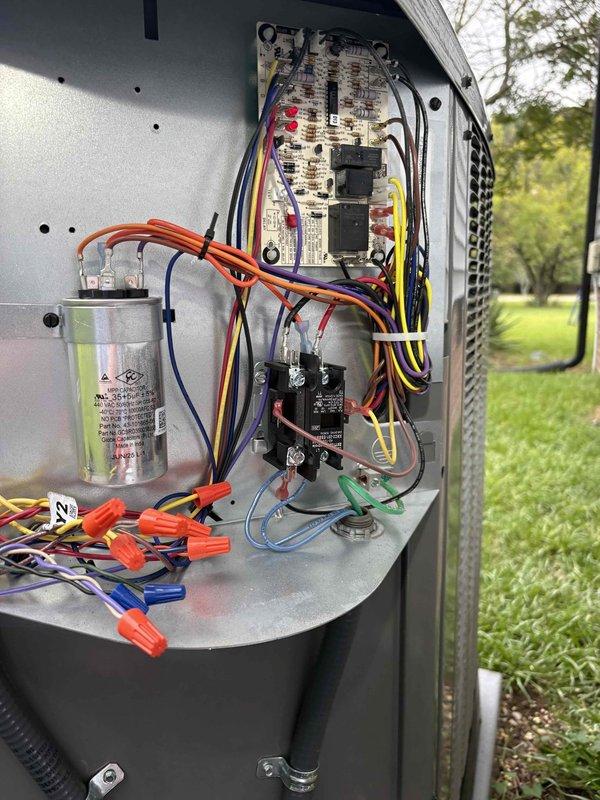Responded to service call for HVAC unit experiencing extended run cycles and temperature discrepancies, with thermostat reading 2 degrees below set point. Inspected outdoor condensing unit and related electrical components, including capacitor, contactors, control board, and wiring connections. Documented system conditions with photos showing outdoor unit interior components and associated electrical switch installation, noting potential correlation with concurrent electrical service work being performed at the property.