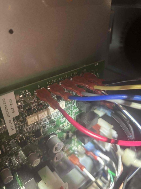 Responded to service call for high indoor humidity levels on 1.5-year-old HVAC system. Performed diagnostic inspection of system controls and circuit board connections. Accessed control panel, verified proper wiring configuration and examined electronic components including thermostat connections and control board functionality to identify potential causes of humidity control issues.