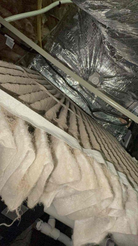 Responded to return service call for air conditioning system not cooling. Upon inspection, accessed attic space and examined HVAC ductwork and insulation for potential airflow restrictions or disconnections. Verified flexible duct connections, supports, and integrity of thermal insulation barriers between conditioned and unconditioned spaces to identify source of cooling failure on one-year-old system.