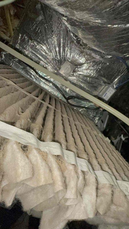 Responded to return service call for air conditioning system not cooling. Upon inspection, accessed attic space and examined HVAC ductwork and insulation for potential airflow restrictions or disconnections. Verified flexible duct connections, supports, and integrity of thermal insulation barriers between conditioned and unconditioned spaces to identify source of cooling failure on one-year-old system.