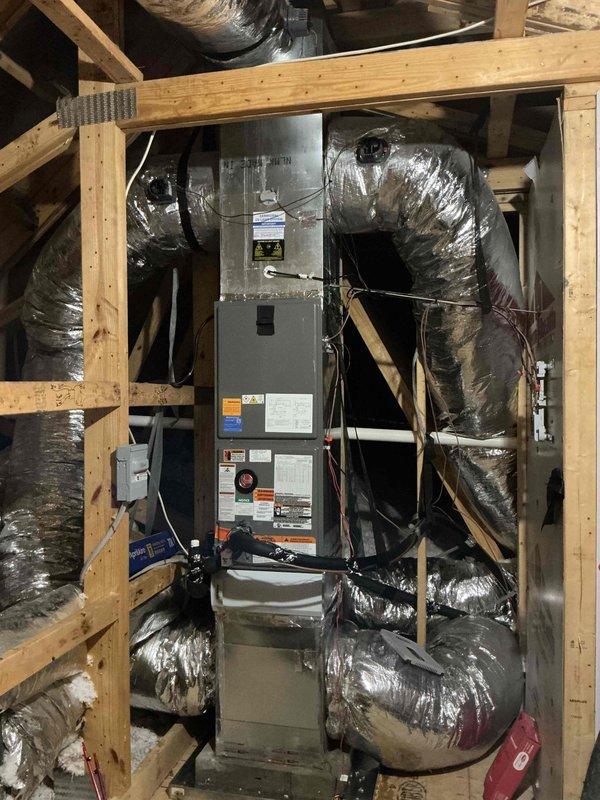 Completed full HVAC system replacement including removal of existing equipment and installation of Rheem RD18AY36AJVCA 3-ton 18 SEER2 variable-speed heat pump condenser with R-454B refrigerant on new outdoor pad, paired with Rheem RH2VY3617STACNJ 3-ton multi-position air handler with 2-stage operation installed in attic space with custom wooden framework. Integrated Tutco 8kW electric heat kit, installed float switches for condensate protection, and completed flexible ductwork connections with proper insulation and securing. Added Ecobee Smart Wi-Fi thermostat with remote sensor and built-in voice control capability, plus TRADEPRO germicidal UVC light kit for enhanced air quality. Performed complete system startup, verified refrigerant charge, tested all electrical connections at 208-230V/1/60Hz, confirmed proper airflow and staging operation across both heating and cooling modes. Disposed of all old equipment through recycling protocols, maintained clean work area throughout installat