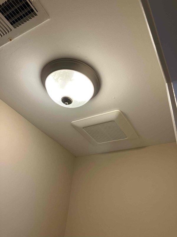 Responded to service call for non-operational bathroom exhaust fan in 2015 home. Upon inspection, found existing 11-year-old unit exhibiting significant corrosion and deterioration. Accessed ceiling cavity and documented existing fan assembly condition, including rusted housing and mounting hardware. Photographed current installation configuration, wiring connections, and ventilation grille for assessment purposes. Provided homeowner with consultation on replacement options, specifications, and sizing requirements for proper bathroom ventilation per code standards.