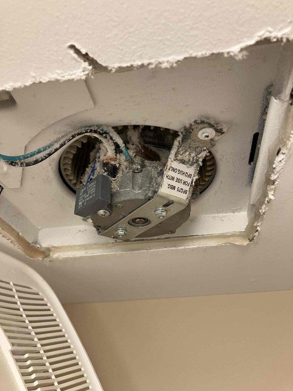 Responded to service call for non-operational bathroom exhaust fan in 2015 home. Upon inspection, found existing 11-year-old unit exhibiting significant corrosion and deterioration. Accessed ceiling cavity and documented existing fan assembly condition, including rusted housing and mounting hardware. Photographed current installation configuration, wiring connections, and ventilation grille for assessment purposes. Provided homeowner with consultation on replacement options, specifications, and sizing requirements for proper bathroom ventilation per code standards.