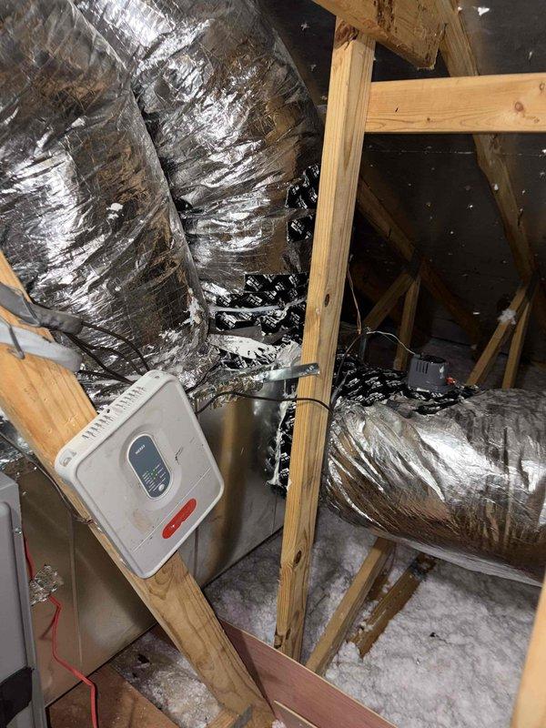 Completed full system replacement installing a Rheem Prestige 4-ton variable-speed heat pump (RD18AY48AJVCA, 18 SEER2, R-454B refrigerant) with matching 5-ton multi-position air handler (RH2VY6024STACNJ, 2-stage, N-coil configuration). Removed and disposed of existing equipment, installed new outdoor condenser pad, and replaced plenum with associated collars. Integrated 10kW Tutco heat kit (HKR-10 Series, 240V) into air handler for supplemental heating. Installed two Honeywell TH2320WF4010/U FocusPro smart thermostats for multi-zone control capability (3 heat/2 cool staging). Added emergency drain pan with float switches for secondary condensate protection. Modified and sealed ductwork connections in attic space using flexible metallic duct. Performed complete system startup, verified proper refrigerant charge, confirmed airflow across all zones, and tested all safety controls. System operational with zone control panel displaying proper staging sequences and temperature readings. All 