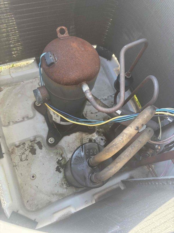 Completed comprehensive heating and air maintenance including 80-point inspection on all units, outdoor coil cleaning, burner cleaning, and gas pressure adjustments. Inspected compressor unit showing surface corrosion on dome component while confirming operational functionality, examined electrical connections and copper refrigerant lines for proper condition, and verified all safety controls. All systems tested and found operating within manufacturer specifications upon completion.