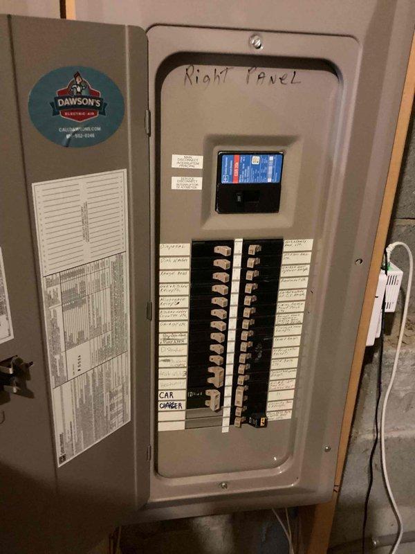 Responded to service call regarding interconnected smoke detectors experiencing frequent false alarms originating from second-floor units in a 2005-built residence with 15 total detectors. Inspected electrical panels and smoke detector circuits to diagnose the cause of weekly nuisance alarms that were triggering the entire interconnected system throughout the home. Documented panel configuration and circuit layout for the smoke detection system.
