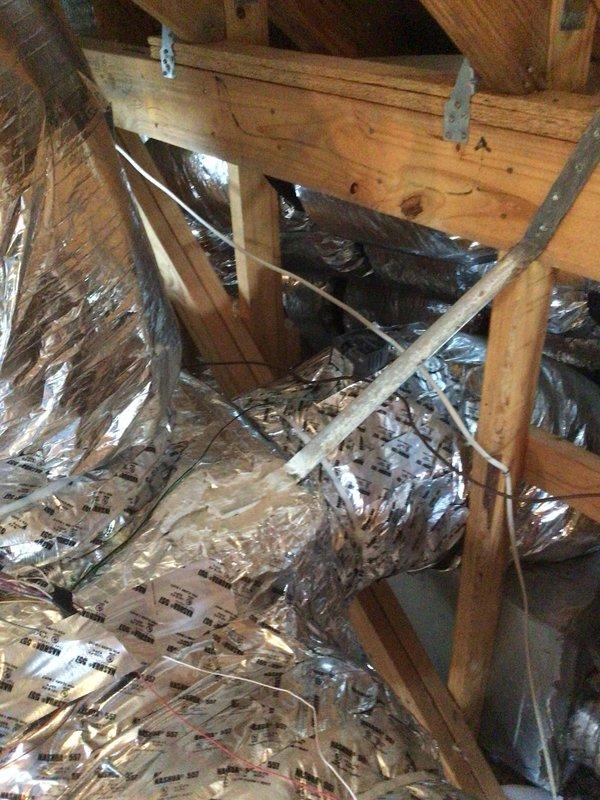 Installed two supply plenums in attic space as part of HVAC system upgrade. Connected flexible aluminum ductwork to central air handler unit mounted on composite platform stand over crawl space area. Additional components required ordering for completion of installation.