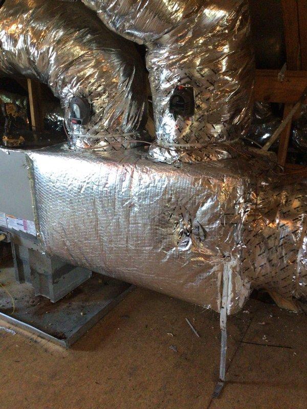 Installed two supply plenums in attic space as part of HVAC system upgrade. Connected flexible aluminum ductwork to central air handler unit mounted on composite platform stand over crawl space area. Additional components required ordering for completion of installation.