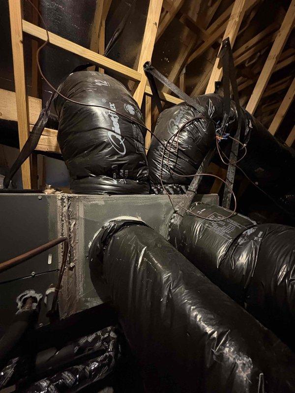 Relocated supply duct from distribution box to main furnace plenum to improve airflow to bedroom. Patched and sealed penetration in distribution box with appropriate materials, then installed manual dampers on three main supply trunk lines to enable zone balancing and temperature control throughout the system.