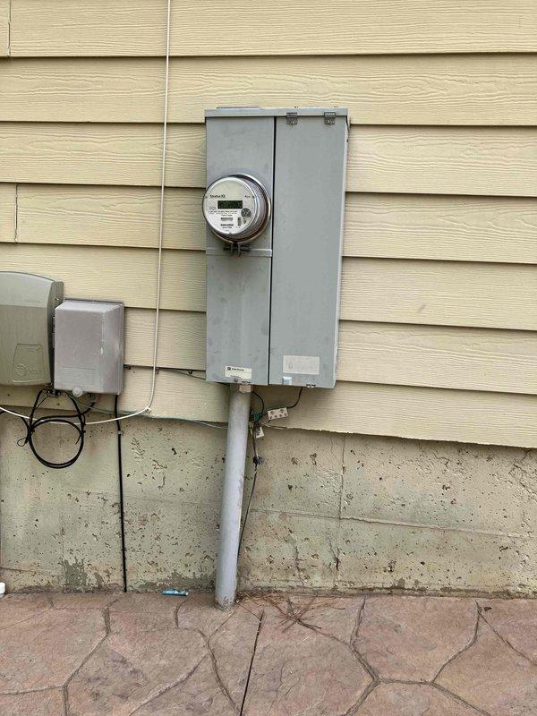 Responded to emergency service call for overheating meter socket reaching temperatures exceeding 100°C with visible melting of components. Upon arrival, inspected exterior meter base and confirmed utility company had temporarily removed and reinstalled meter. Advised customer to immediately reduce electrical load by shutting off HVAC systems and high-draw appliances to prevent further damage until meter socket replacement could be completed. Documented conditions of both exterior meter enclosure and interior main electrical panel for repair planning.