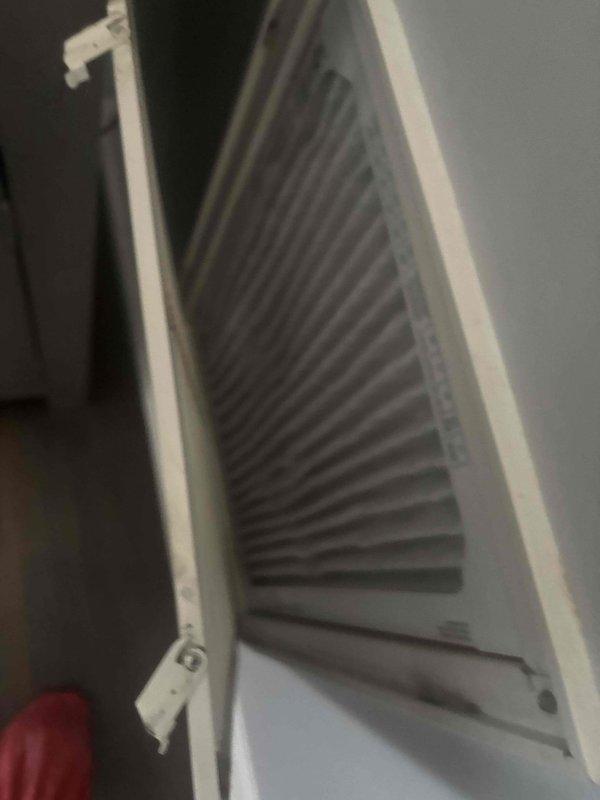 Responded to no cooling complaint on single-zone HVAC system reportedly installed in 2022. Upon arrival, system was running but not providing adequate cooling as reported. Performed diagnostic inspection of indoor air handler unit, accessing internal components including blower assembly, filter compartment, and evaporator coil section. Conducted electrical system evaluation by inspecting control panel, contactors, relays, and printed circuit board for proper operation and connections. Verified all wire terminations, control voltage circuits, and safety devices. Assessed airflow through supply grille and examined filter condition. Instructed occupant to power down system prior to arrival to prevent potential compressor damage. Documented equipment condition through photographic records of air handler interior components and electrical control panel assembly for service records.