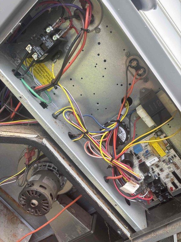 Responded to no cooling complaint on single-zone HVAC system reportedly installed in 2022. Upon arrival, system was running but not providing adequate cooling as reported. Performed diagnostic inspection of indoor air handler unit, accessing internal components including blower assembly, filter compartment, and evaporator coil section. Conducted electrical system evaluation by inspecting control panel, contactors, relays, and printed circuit board for proper operation and connections. Verified all wire terminations, control voltage circuits, and safety devices. Assessed airflow through supply grille and examined filter condition. Instructed occupant to power down system prior to arrival to prevent potential compressor damage. Documented equipment condition through photographic records of air handler interior components and electrical control panel assembly for service records.