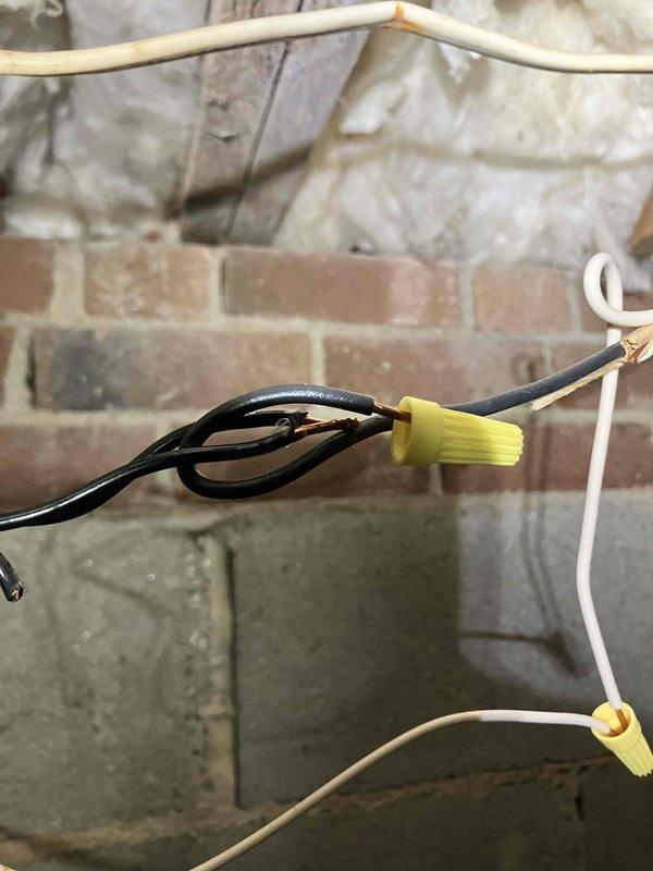 Completed annual 32-point electrical system evaluation and preventative maintenance service. Performed comprehensive electrical panel maintenance including torque verification and connection inspection of all breakers and bus bars. Conducted testing of all GFCI and shock protection outlets and breakers to verify proper ground fault protection functionality. Tested arc fault circuit interrupter breakers to ensure fire protection systems operating within specifications. Performed smoke and carbon monoxide detector maintenance including battery replacement and operational testing throughout residence. Replaced customer-supplied light bulbs in fixtures up to 12 feet and cleaned ceiling fans up to 12 feet. During attic inspection, identified electrical junction connections with exposed copper conductors showing oxidation and improper wire nut connections in insulated space. Documented substandard wiring junctions requiring attention for safety and code compliance. All accessible electrical 