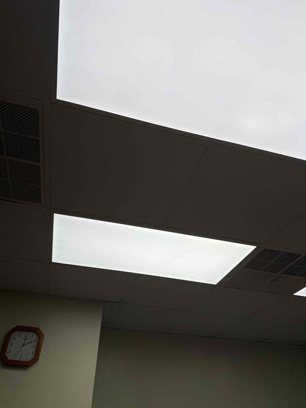 Replaced fluorescent light fixture in kitchen area and replaced lighting fixture in Penguin 2 room. Both fixtures were installed in drop ceiling systems at approximately 8-10 foot heights. Verified proper operation of all replacement lighting upon completion.