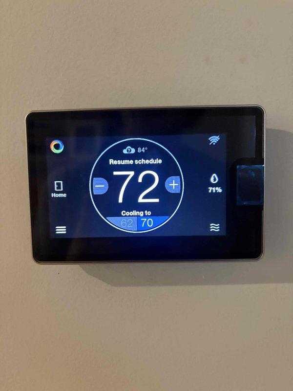 Completed installation and configuration of zoning system with advanced climate control capabilities. Programmed wall-mounted smart thermostat with dehumidification settings, establishing 50% humidity set point with 1°F over-cooling amount and 5-minute dehumidification drain timer. Verified proper system operation with cooling function active and humidity monitoring displaying 71% current reading at 72°F ambient temperature.