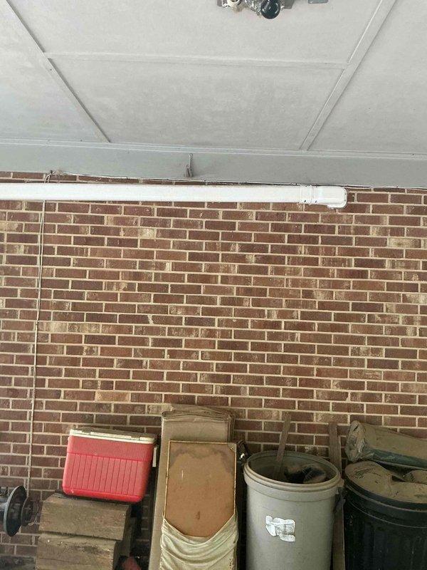 Completed installation of Mitsubishi Electric ductless mini-split air conditioning system. Mounted indoor wall unit on interior cream-colored wall and installed outdoor condenser unit. Ran refrigerant lines and electrical connections through wall penetration, secured condensate drain line, and verified proper system operation with successful startup and testing.