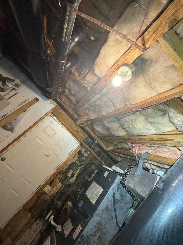 Responded to service call for newly installed HVAC system running but not delivering airflow. Upon inspection, identified blower motor or air handler operational issue in basement-mounted unit. Accessed attic ductwork system to verify proper installation and connections of supply plenum and trunk lines. Documented existing insulation conditions and HVAC equipment installation for possible recall investigation related to recent system installation.