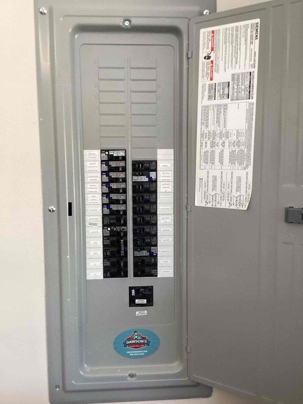 Responded to service call regarding flickering ceiling fan light in recently constructed residence. Inspected electrical panel to verify proper circuit breaker operation and confirm adequate power supply to affected circuit. Documented panel configuration and circuit distribution for reference, finding all breakers properly seated and functioning within normal parameters.