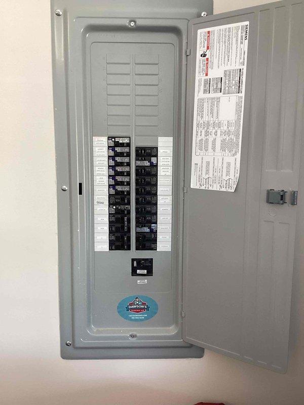 Responded to service call regarding flickering ceiling fan light in recently constructed residence. Inspected electrical panel to verify proper circuit breaker operation and confirm adequate power supply to affected circuit. Documented panel configuration and circuit distribution for reference, finding all breakers properly seated and functioning within normal parameters.
