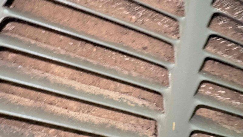 Responded to service call for air conditioning system not operating with drain pan collecting water. Accessed attic unit using extension ladder due to location over stairwell. Upon inspection, found condensate drain line clogged, causing primary drain pan to overflow and triggering float switch safety shutoff. Cleared drain line obstruction and verified proper drainage flow. Inspected air handler, ductwork, and return air filter. Restored system to normal operation and confirmed unit cooling properly with condensate draining as designed.