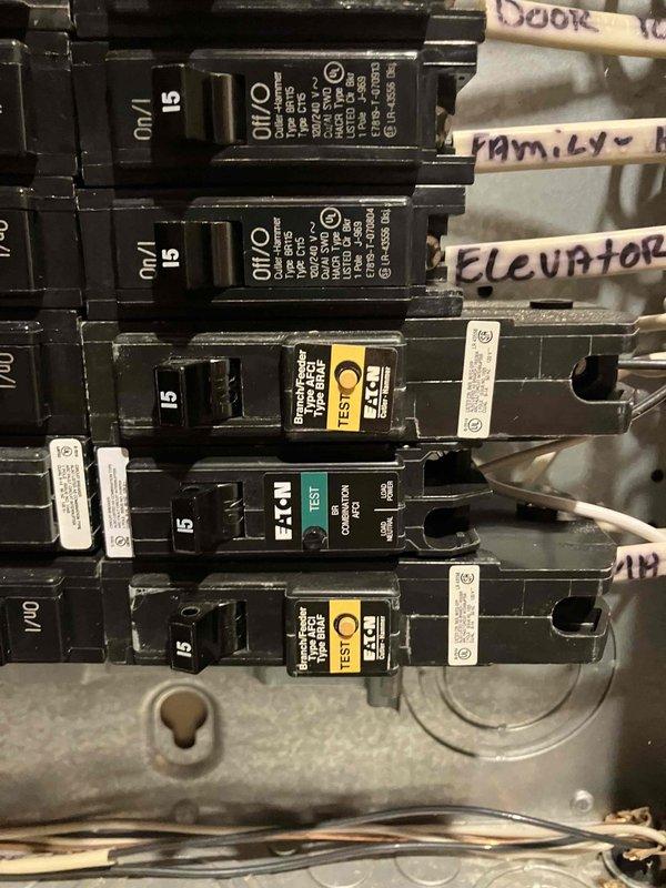 Responded to service call regarding third-floor bedroom circuit breaker that would not reset following water damage repairs and ceiling restoration work. Upon arrival, inspected main electrical panel in 2007 construction home and located affected 15-amp circuit breaker that had been in off position for approximately one month during water remediation. Previous contractor reported sparking when attempting to reset breaker after completing ceiling fan reinstallation and drywall repairs.

Performed visual inspection of electrical panel revealing significant insect debris accumulation within breaker compartment and around circuit connections, indicating potential compromised environmental sealing. Examined breaker in question and surrounding circuits for signs of water intrusion, corrosion, or heat damage that could explain sparking incident. Panel contained mix of standard breakers and AFCI/GFCI combination breakers with test buttons, all manufactured by Eaton.

Documented panel condition