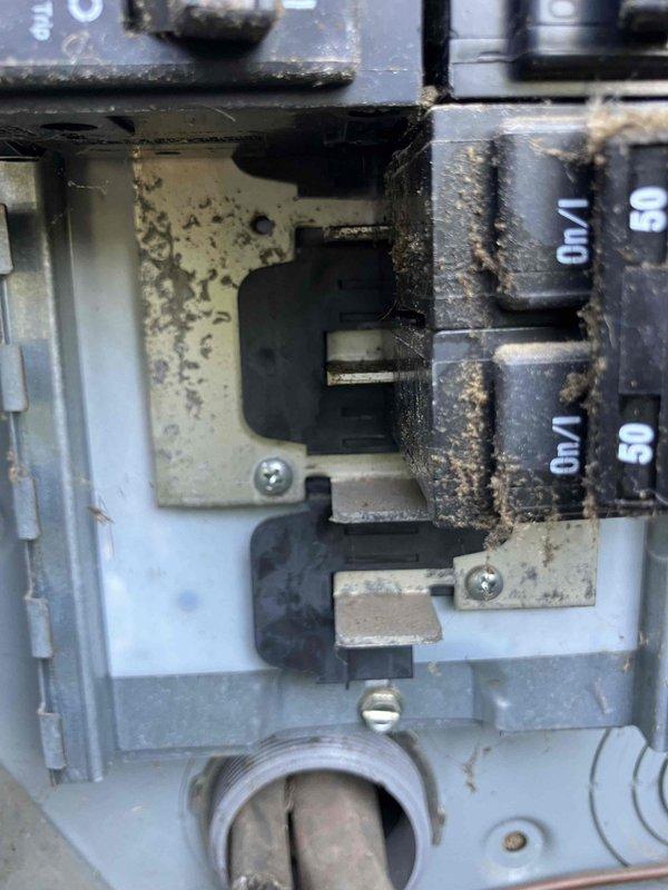Responded to service call regarding third-floor bedroom circuit breaker that would not reset following water damage repairs and ceiling restoration work. Upon arrival, inspected main electrical panel in 2007 construction home and located affected 15-amp circuit breaker that had been in off position for approximately one month during water remediation. Previous contractor reported sparking when attempting to reset breaker after completing ceiling fan reinstallation and drywall repairs.

Performed visual inspection of electrical panel revealing significant insect debris accumulation within breaker compartment and around circuit connections, indicating potential compromised environmental sealing. Examined breaker in question and surrounding circuits for signs of water intrusion, corrosion, or heat damage that could explain sparking incident. Panel contained mix of standard breakers and AFCI/GFCI combination breakers with test buttons, all manufactured by Eaton.

Documented panel condition