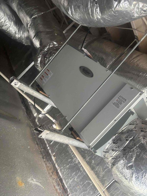 Responded to customer complaint of elevated indoor humidity levels at 70%. Accessed attic-mounted air handler unit and performed system diagnostics. Measured supply air temperature at 60.2°F using digital thermometer to verify cooling operation. Inspected air handler, ductwork connections, and overall system installation for proper operation and potential causes of humidity control issues.