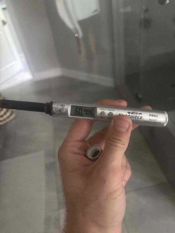 Responded to customer complaint of elevated indoor humidity levels at 70%. Accessed attic-mounted air handler unit and performed system diagnostics. Measured supply air temperature at 60.2°F using digital thermometer to verify cooling operation. Inspected air handler, ductwork connections, and overall system installation for proper operation and potential causes of humidity control issues.