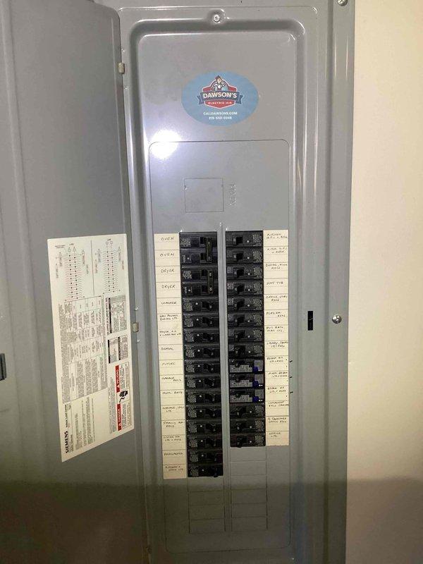 Completed generator consultation at a residential property built in 2002 with existing propane gas service via rental tank. Assessed electrical panel configuration and existing utility connections, documenting current breaker layout and exterior meter installation to determine feasibility and requirements for standby generator installation.
