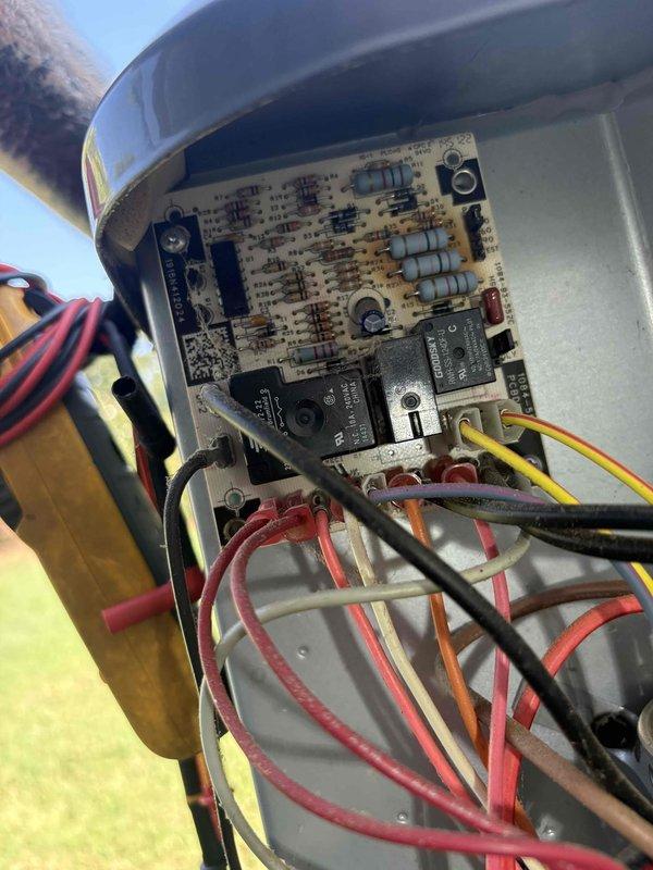 Responded to no cooling call on 2005 system where outdoor unit was running but thermostat had no power. Inspected control board in outdoor unit and found multiple wire connections loose at terminal block with evidence of corrosion and age-related deterioration. Traced low voltage wiring from outdoor unit through attic space and identified damaged thermostat wire with compromised insulation near deteriorated attic insulation. Replaced faulty thermostat wire run, secured all connections at control board, and restored power to thermostat. Verified system operation with proper communication between thermostat and equipment. Advised of aging equipment condition and recommended monitoring for future reliability concerns.