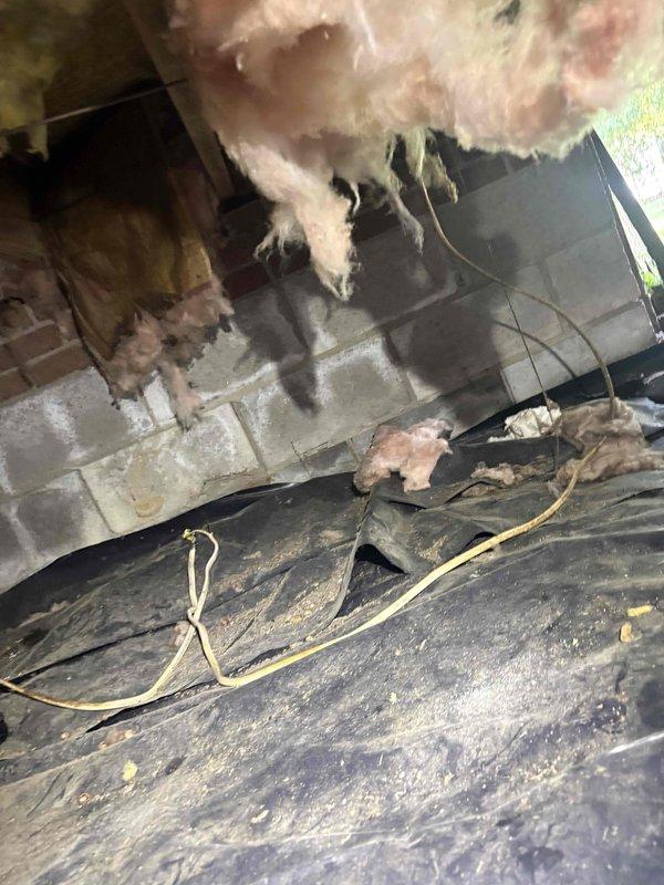 Responded to no cooling call on 2005 system where outdoor unit was running but thermostat had no power. Inspected control board in outdoor unit and found multiple wire connections loose at terminal block with evidence of corrosion and age-related deterioration. Traced low voltage wiring from outdoor unit through attic space and identified damaged thermostat wire with compromised insulation near deteriorated attic insulation. Replaced faulty thermostat wire run, secured all connections at control board, and restored power to thermostat. Verified system operation with proper communication between thermostat and equipment. Advised of aging equipment condition and recommended monitoring for future reliability concerns.