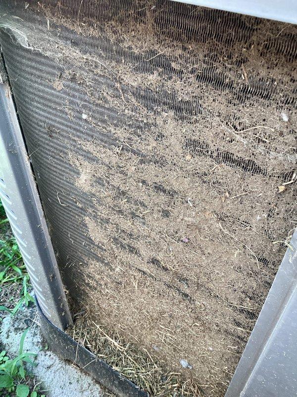 Responded to no cooling complaint on 3-year-old residential HVAC system. Upon inspection, found outdoor condenser coil heavily contaminated with dirt, dust, grass clippings, and organic debris significantly restricting airflow. Tested run capacitor and found it reading 38.10 μF against rated capacity of 10 μF, indicating capacitor failure. Cleaned condenser coil to restore proper airflow and replaced failed run capacitor with proper rated component. Verified system operation with thermostat communication restored and unit cooling properly.