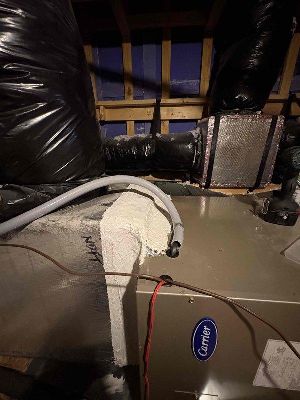 Responded to attic service call regarding condensation and water accumulation around air handler unit. Inspected 2024 Carrier air handler and associated ductwork connections for air seal integrity. Resealed all penetrations and connections on the AC unit to prevent moisture intrusion and ensure proper environmental separation between conditioned and unconditioned spaces.