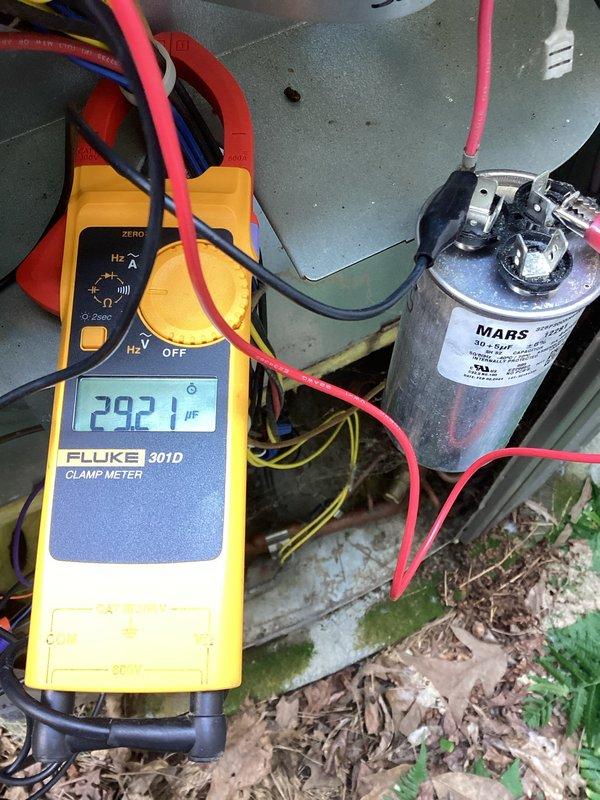 Completed comprehensive heating and air maintenance on 2012 single-system unit including 80-point inspection, outdoor coil cleaning, burner cleaning, gas pressure adjustments, and safety inspections. Tested capacitor function using clamp meter, which showed 29.21 µF reading on MARS capacitor. Replaced heavily soiled air filter with clean unit to restore proper airflow and system efficiency.