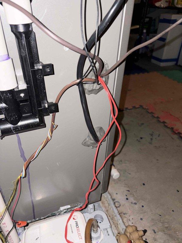 Completed HVAC system installation including outdoor condensing unit and interior air handler components. Verified proper electrical connections and wire routing within equipment panels, secured all wiring with appropriate clips and fasteners. Leveled outdoor unit to manufacturer specifications and confirmed stable mounting on pad. All electrical terminations inspected and tested for proper voltage and amperage readings prior to system startup.