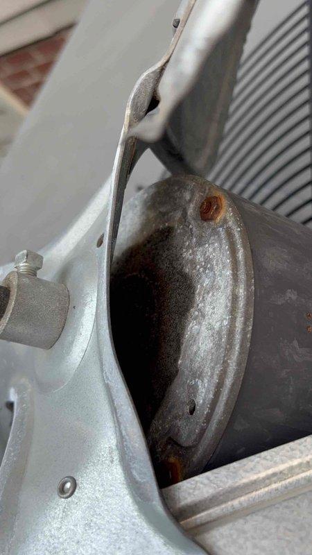 Responded to a no-cool service call to provide a second opinion on reported coil issues for an 11-20 year old HVAC system. Upon inspection, found evidence of significant deterioration and rust accumulation around the evaporator coil housing and blower assembly, indicating moisture intrusion and potential refrigerant leak concerns. Documented equipment condition with photographs showing corrosion patterns on coil access port and aging blower motor components, confirming the need for coil evaluation and possible replacement to restore proper cooling operation.