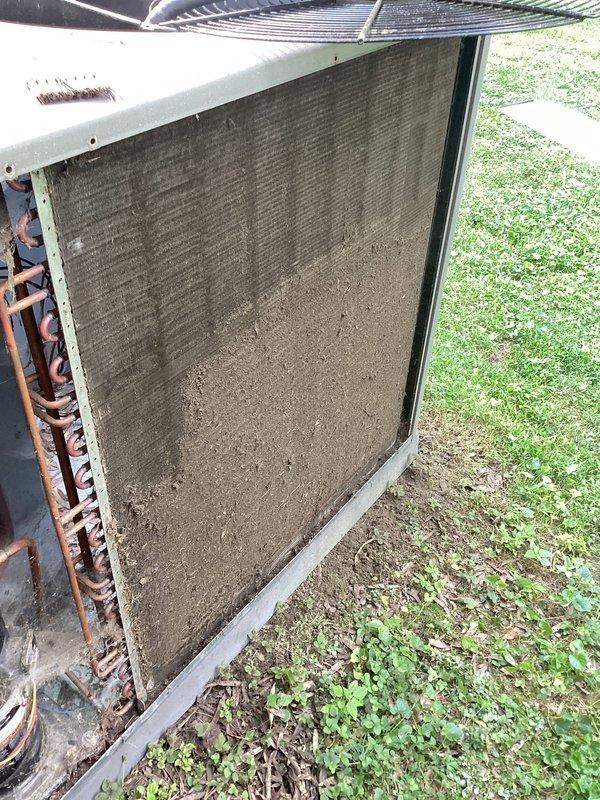 Responded to no cooling complaint on residential air conditioning system. Upon arrival, performed visual inspection of outdoor condensing unit and found condenser coil heavily obstructed with dirt, dust, and debris accumulation, particularly in lower two-thirds of coil surface. Excessive buildup was restricting airflow through coil fins, significantly impeding heat transfer capability and preventing unit from operating efficiently.

Accessed electrical compartment and performed diagnostic testing of system components. Used clamp meter to measure capacitance of run capacitor, obtaining reading of 35.82 μF. Verified capacitor specifications against manufacturer nameplate on REPHON brand capacitor. Inspected refrigerant line connections and electrical wiring for signs of damage or deterioration.

Primary issue identified as severely restricted condenser coil preventing adequate heat rejection from refrigerant system, resulting in loss of cooling capacity. Recommended thorough coil cleanin