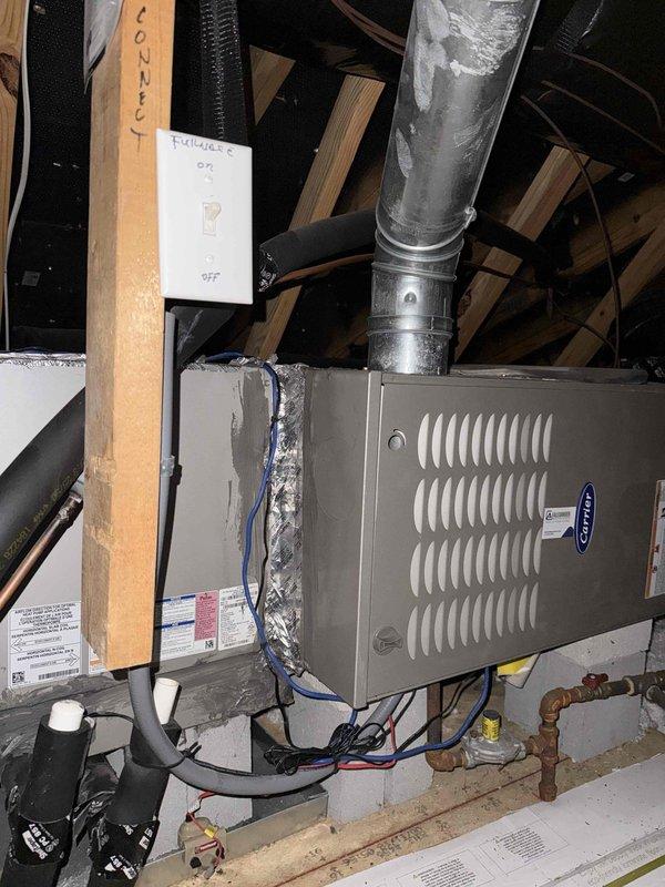 Completed annual 32-point electrical system evaluation on 2018 home. Performed electrical panel maintenance including torque verification and connection inspection. Tested all GFCI outlets and breakers for proper shock protection functionality. Verified arc fault breakers for fire protection performance. Conducted smoke and CO2 detector maintenance with battery replacement and operational testing. Replaced customer-supplied light bulbs in fixtures up to 12 feet and cleaned ceiling fans up to 12 feet. Noted wall damage around one duplex receptacle requiring drywall repair. All electrical components tested within normal operating parameters.