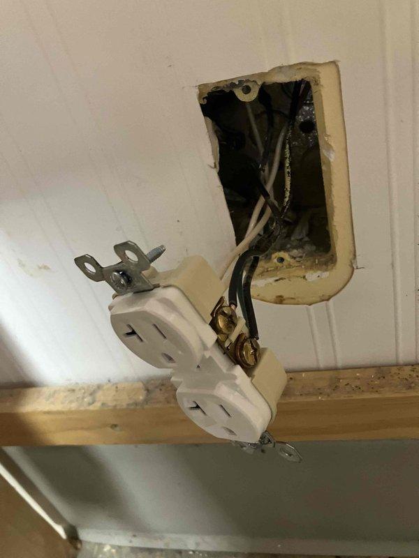 Responded to non-functioning outlet in Hummingbirds 1 room. Upon inspection, found outlet had been pulled away from wall opening with exposed wiring and damaged mounting. Assessed electrical box cavity, verified wire connections including hot, neutral, and ground conductors, and inspected ceiling access point where additional wiring was routed through structural beam. Restored proper outlet installation, secured mounting bracket, and verified circuit functionality upon completion.