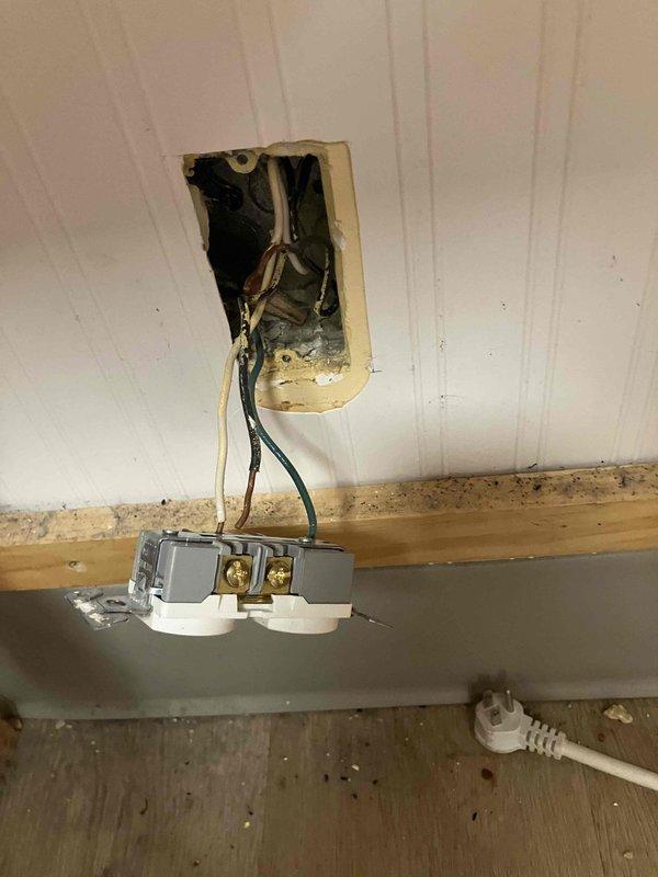 Responded to non-functioning outlet in Hummingbirds 1 room. Upon inspection, found outlet had been pulled away from wall opening with exposed wiring and damaged mounting. Assessed electrical box cavity, verified wire connections including hot, neutral, and ground conductors, and inspected ceiling access point where additional wiring was routed through structural beam. Restored proper outlet installation, secured mounting bracket, and verified circuit functionality upon completion.