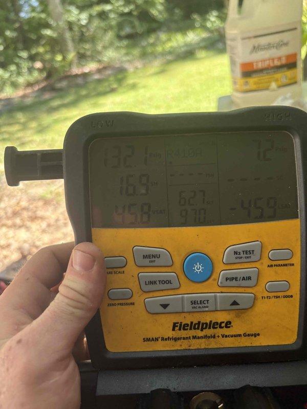 Responded to no cool call on Mitsubishi Electric mini-split system in living room with water draining indoors instead of outdoors. Diagnosed clogged condensate drain line preventing proper drainage. Cleared obstruction from drain line, verified proper water flow to exterior, tested system operation with manifold gauges, and confirmed unit cooling properly with no further drainage issues.