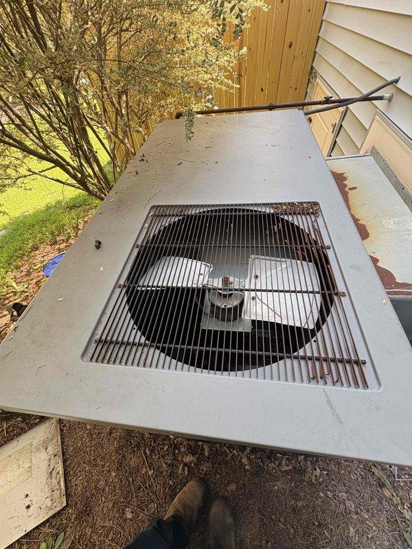 Responded to no cooling complaint on 10-year-old system. Upon inspection, found evaporator coil heavily soiled with dust and debris accumulation in attic unit, restricting airflow. Outdoor condensing unit showed signs of age with rust formation on cabinet and grille, though fan operation appeared normal. Documented equipment condition with photos showing compromised coil cleanliness and outdoor unit deterioration requiring attention to restore proper cooling capacity.