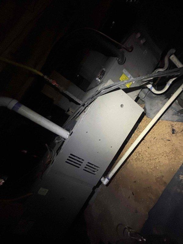 Responded to no cooling complaint on downstairs air conditioning unit in a two-system residence with 20-year-old equipment. Upon arrival, found thermostat displaying 77°F with system calling for cooling but unit not providing adequate temperature reduction. Inspected downstairs HVAC system located in basement utility area, evaluated unit operation, and assessed thermostat functionality to diagnose cooling failure.