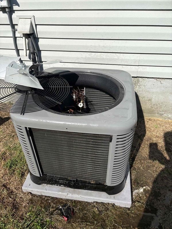 Responded to no-cooling complaint on recently installed residential air conditioning system at rental property. Upon arrival, found outdoor condensing unit with heavily clogged condenser coil and debris accumulation inside top panel, including leaves and organic matter restricting airflow. Documented excessive dirt and grass clippings on filter screen and coil surface, causing significant reduction in heat transfer efficiency and preventing unit from reaching setpoint temperature. Advised homeowner that system requires immediate cleaning and possible warranty evaluation due to recent installation. Recommended contacting property owner to review findings and determine appropriate corrective action.