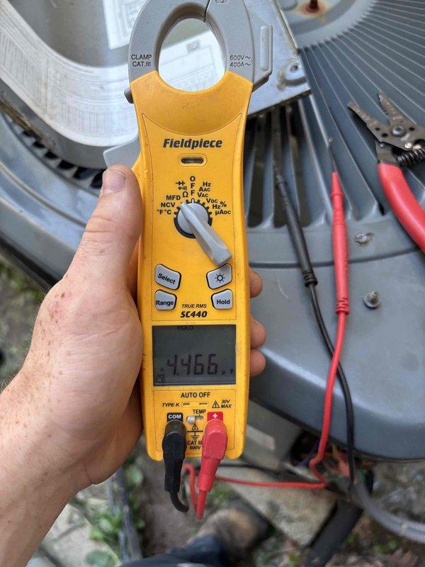 Responded to second opinion request on 9-year-old system reported to have refrigerant leak by previous contractor. Performed diagnostic evaluation of outdoor condenser unit with electrical measurements using clamp meter. Inspected indoor blower assembly and evaporator components, noting dust accumulation on blower wheel indicating maintenance needs. Provided assessment findings to verify system condition and refrigerant leak diagnosis.