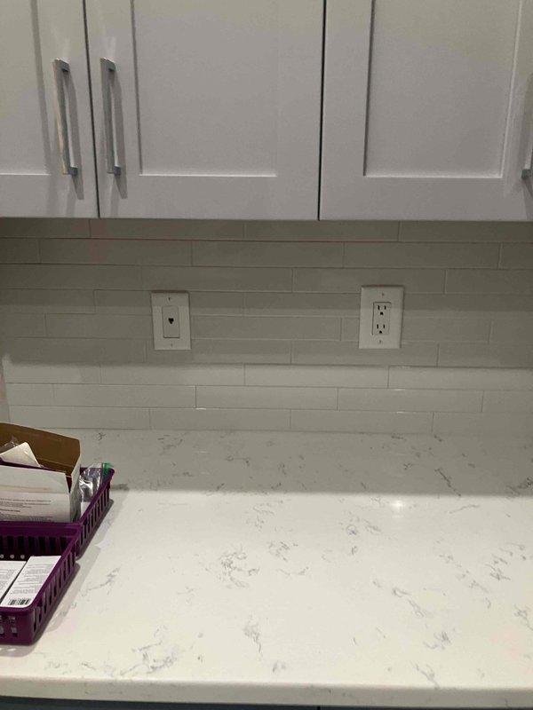 Completed comprehensive electrical installation in kitchen including supply and installation of fire rings on newly tiled backsplash for all electrical devices to ensure proper code compliance and safety. Installed new 20-amp breaker in electrical panel dedicated to above-range microwave circuit. Added new two-pole breaker for disposal and dishwasher circuit to provide adequate power distribution and circuit protection. Installed outlet for customer-supplied above-range microwave and mounted unit securely above cooktop area. Installed customer-supplied sink light fixture with proper wiring and switching. All electrical connections tested for proper operation, polarity, and ground continuity. Work completed to meet current NEC standards with three-year warranty on parts and labor provided, extended five-year warranty available.