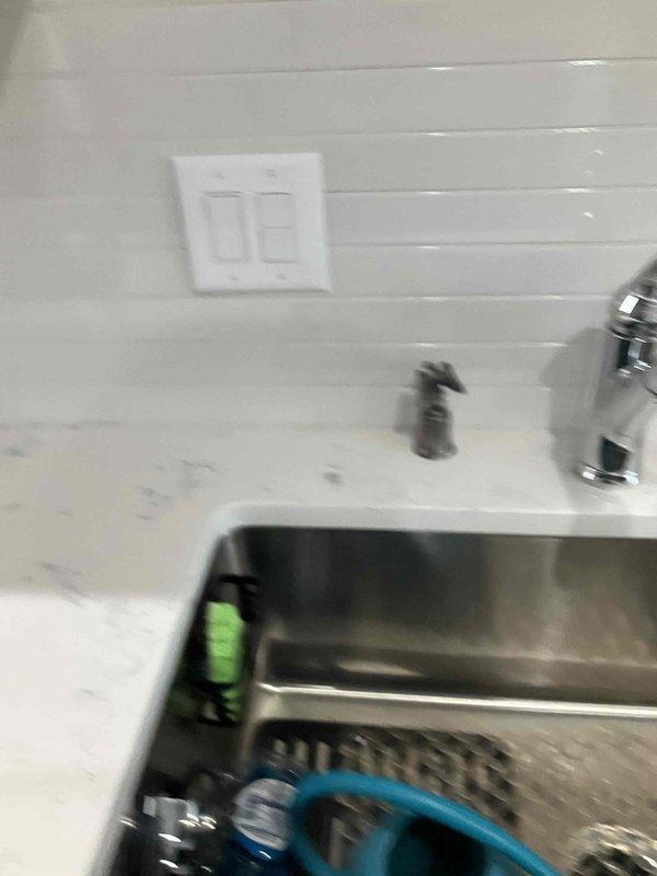 Completed comprehensive electrical installation in kitchen including supply and installation of fire rings on newly tiled backsplash for all electrical devices to ensure proper code compliance and safety. Installed new 20-amp breaker in electrical panel dedicated to above-range microwave circuit. Added new two-pole breaker for disposal and dishwasher circuit to provide adequate power distribution and circuit protection. Installed outlet for customer-supplied above-range microwave and mounted unit securely above cooktop area. Installed customer-supplied sink light fixture with proper wiring and switching. All electrical connections tested for proper operation, polarity, and ground continuity. Work completed to meet current NEC standards with three-year warranty on parts and labor provided, extended five-year warranty available.