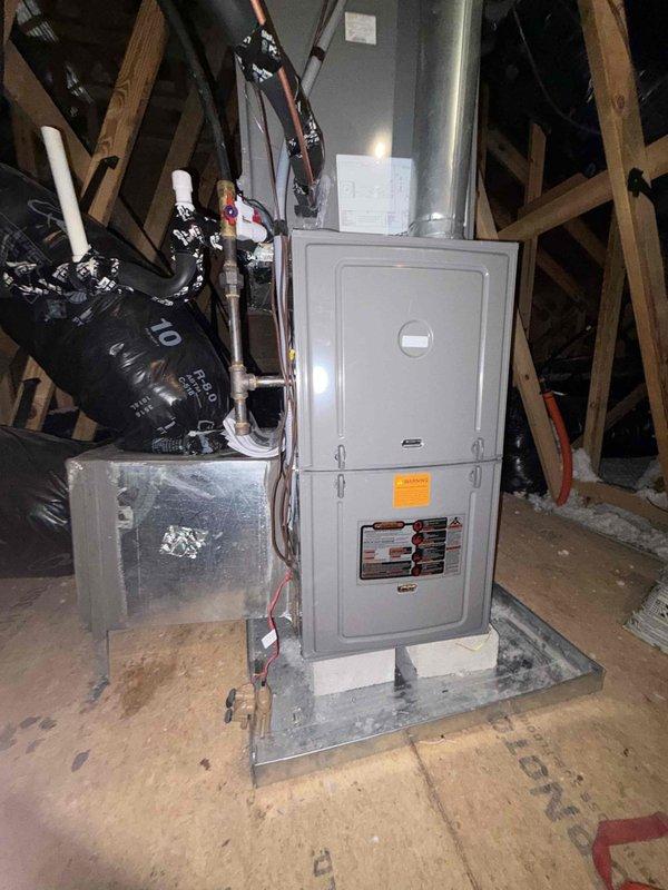 Completed full HVAC system installation in attic space consisting of Rheem Endeavor™ Line 3.5 ton 14.3 SEER2 condenser (Model RA14AY42AJ1NA) with R-454B refrigerant, 4 ton N-coil cased evaporator coil (Model RCFY4821STANMC) with TXV, and Classic 80% AFUE single-stage gas furnace (Model R801T0754A17UHSNAS) rated at 75,000 BTU with constant torque motor and standard NOx emissions. Mounted furnace unit on metal platform in attic with proper clearances and structural support. Connected metallic supply plenum and installed vertical main trunk ductwork extending from furnace. Ran and secured copper refrigerant line set between outdoor condenser and indoor evaporator coil. Installed black flexible return air ductwork to furnace intake. Completed all electrical connections including 208-230V single-phase power supply to condenser and low-voltage control wiring between units. Installed white PVC condensate drain lines with proper pitch and termination. Verified all gas connections to furnace wi