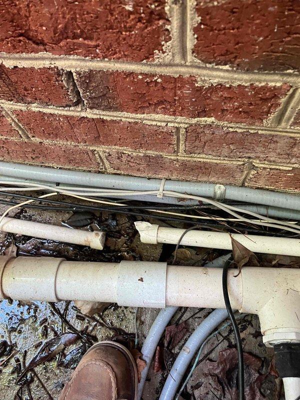Responded to possible recall for tripping breakers at 1995 residential property with previous lightning strike history from 2024. Investigated reported issues with two salt system breakers and one booster breaker that were intermittently tripping. Verified power supply to daughter's ceiling fan and light fixture to determine if electrical circuit was functioning properly and providing adequate power to the fixture location. Documented exterior utility infrastructure and conduit routing along brick foundation for service records.