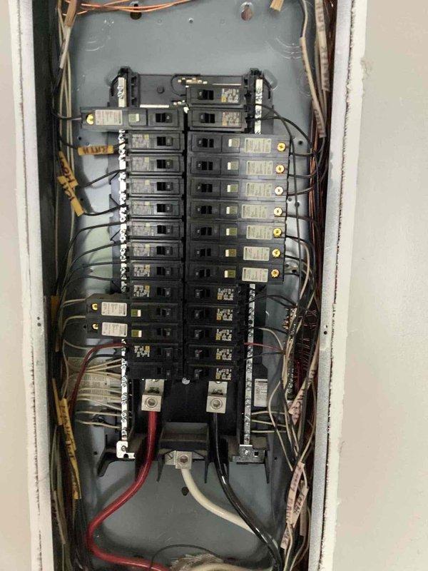 Responded to service call for ceiling fan replacement at residence built in 2005. Customer had three Minka Air outdoor ceiling fans with one unit requiring replacement. Verified electrical panel configuration and existing wiring to ensure compatibility between new replacement fan and two existing operational units previously installed. Confirmed that new Minka Air model could be integrated with current wiring system and would operate in conjunction with remaining fans. Inspected flush-mount ceiling fan installation on beadboard ceiling, verified proper electrical connections, and documented electrical panel showing organized circuit breaker layout with appropriate wire gauging and connections. Ensured all three fans would function properly on existing circuit with compatible controls.